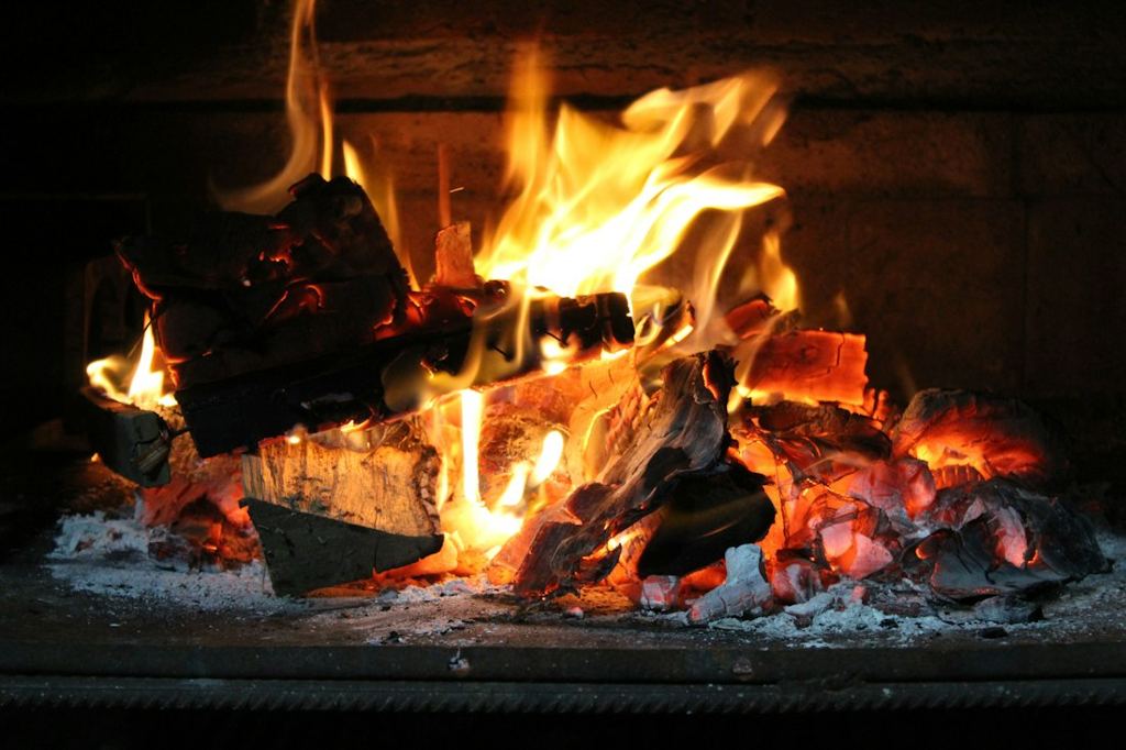 Bûches qui crépitent dans une cheminée, flammes et braises